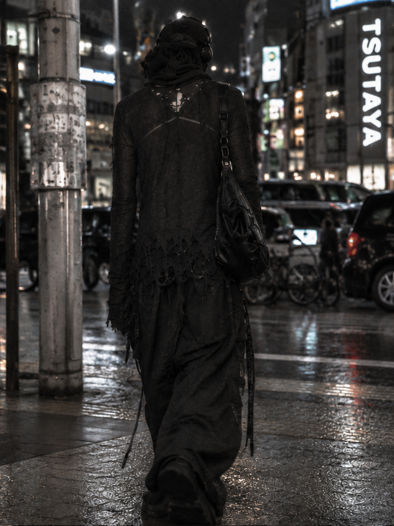 Dark gothic layered outfit in a rainy city at night